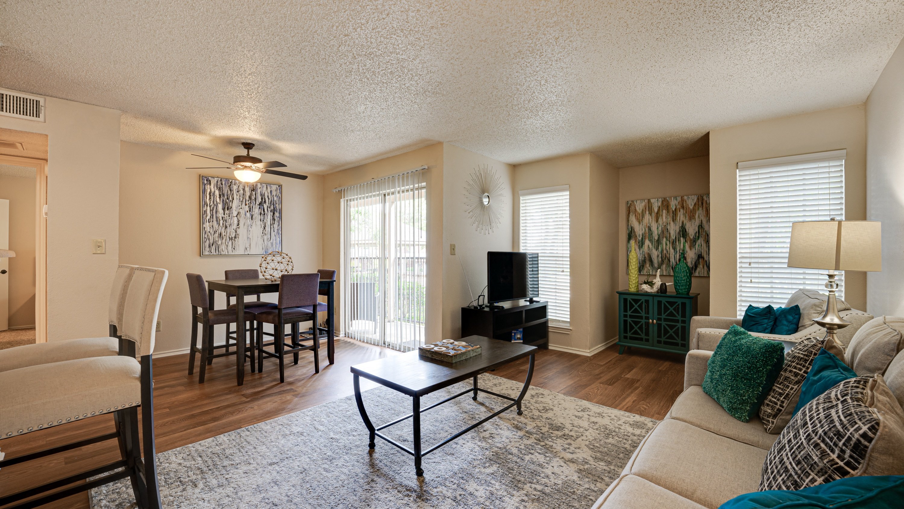 a living room and dining room with a couch and a table